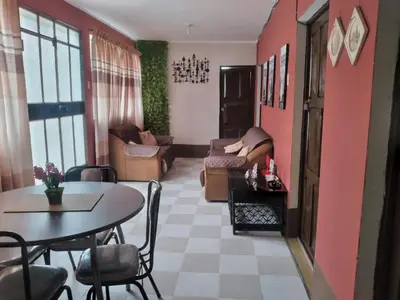 a living room with a table and a couch at Casa Hospedaje in Ayacucho
