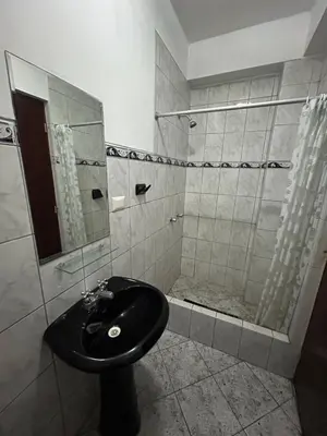 a bathroom with a black sink and a shower at Aquarium in Lima