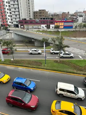 a group of cars parked on a city street at Aquarium in Lima