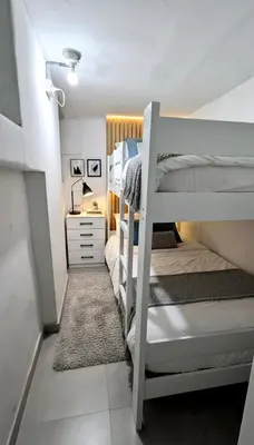 a bedroom with two bunk beds and a desk at Departamento en el Centro Historico de Lima Perú in Lima