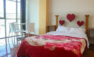 a bedroom with a bed with hearts on the wall at Yanachaga Hotel - Oxapampa in Oxapampa