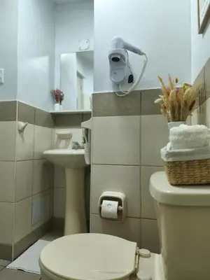 a bathroom with a toilet and a sink at Habitación Baño Compartido en Departamento Compartido in Lima