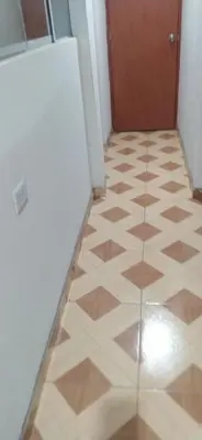 a hallway with a tile floor and a door at Casa de Campo y Hospedaje Irma in Lunahuaná
