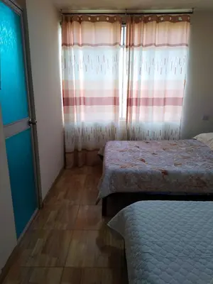 a bedroom with two beds and a window at Casa de Campo y Hospedaje Irma in Lunahuaná