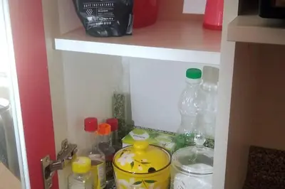 a cupboard filled with bottles of water and other items at Depawanka 3 Departamento amoblado y equipada in Huancayo