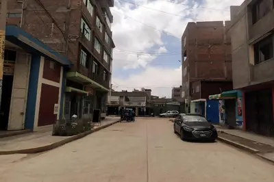 a black car parked on a city street with buildings at Depawanka 3 Departamento amoblado y equipada in Huancayo