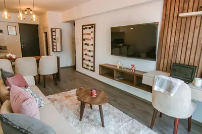 a living room with a couch and a tv at Moderno Loft a Pasos del Centro in Cusco