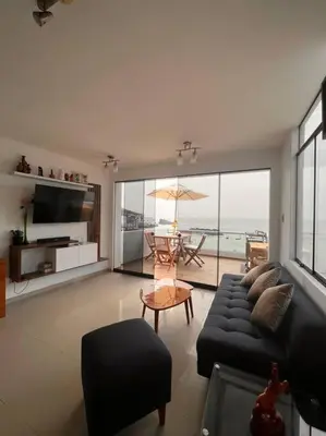 a living room with a couch and a table at Departamento COCO - San Bartolo in San Bartolo