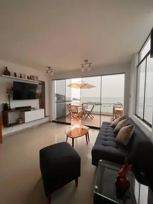 a living room with a couch and a table at Departamento COCO - San Bartolo in San Bartolo