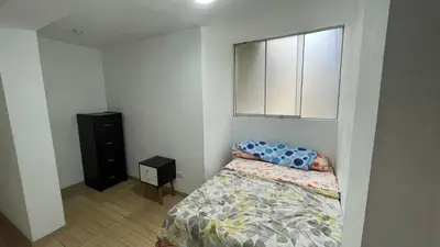 a small bedroom with a bed and a window at Acogedor departamento en Los Olivos 3 dormitorios in Lima