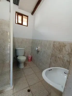 a bathroom with a toilet and a bath tub at INCA COFFEE Lodge Lucmabamba in Sahuayacu