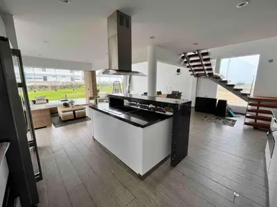 a kitchen with a stove and a staircase in a room at Casa de Playa muy cerca al mar, piscina exclusiva! in Islote Los Leones
