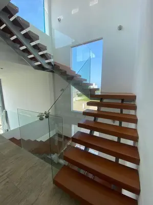 a staircase in a house with a glass railing at Casa de Playa muy cerca al mar, piscina exclusiva! in Islote Los Leones