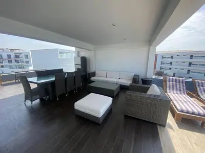 a room with a balcony with a table and chairs at Casa de Playa muy cerca al mar, piscina exclusiva! in Islote Los Leones