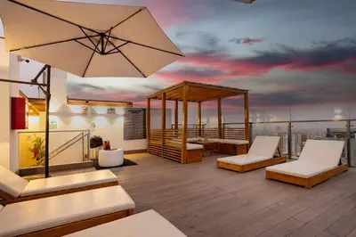 a rooftop deck with a view of the city at G15 Apartments by Vibrant in Lima