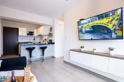 a living room with a flat screen tv on a wall at G15 Apartments by Vibrant in Lima