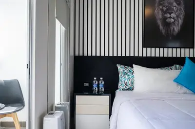 a bedroom with a bed with a lion on the wall at G15 Apartments by Vibrant in Lima