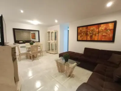 a living room with a couch and a table at Apartame in Lima