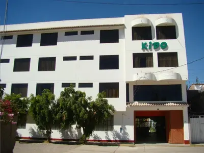 a white building with a kroo sign on it at Kibo Hotel in Ayacucho