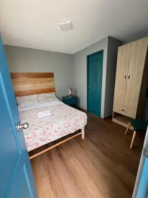 a bedroom with a bed and a blue door at Hospedaje Milan in Lima