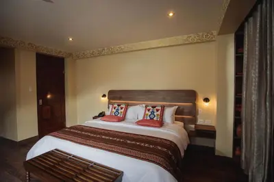a bedroom with a large bed with red pillows at Valle Del Sol in Urubamba