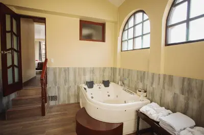a bathroom with a large tub in a room at Valle Del Sol in Urubamba