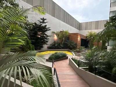 a courtyard with trees and plants in a building at Deluxe Apartment in San Isidro in Lima
