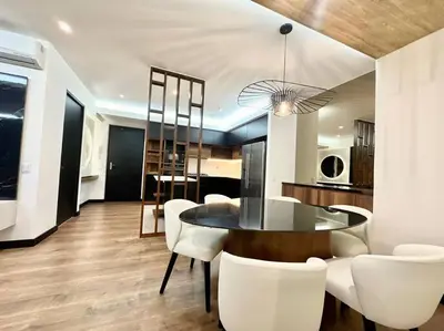 a dining room with a table and white chairs at Deluxe Apartment in San Isidro in Lima