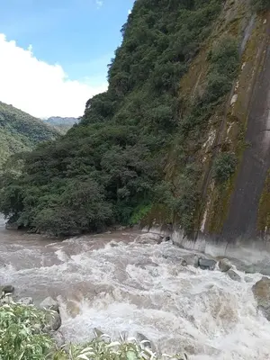 a river with rapids on the side of a mountain at Susanna Inn MachuPicchu Hotel in Machu Picchu