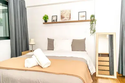 a bedroom with a bed with two towels on it at Willka Wasi Cusco in Cusco