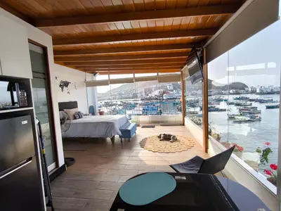 a bedroom with a bed and a view of a harbor at Lindo chalet en PUCUSANA in Pucusana