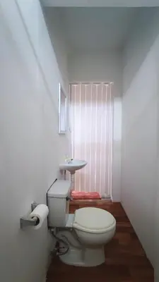 a bathroom with a toilet and a sink at Ninfas 371 in Pucusana