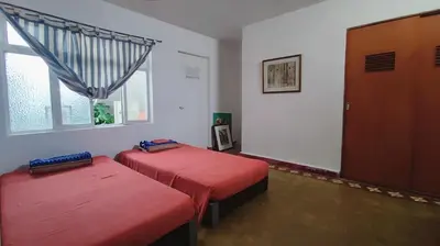a room with two beds and a window at Ninfas 371 in Pucusana