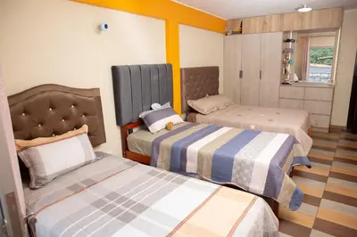 a room with three beds in a room at Apartamento La Merced in La Merced