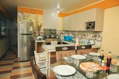 a kitchen with a table and chairs and a refrigerator at Apartamento La Merced in La Merced