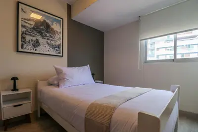 a bedroom with a white bed and a window at Stelar by Wynwood House in Lima
