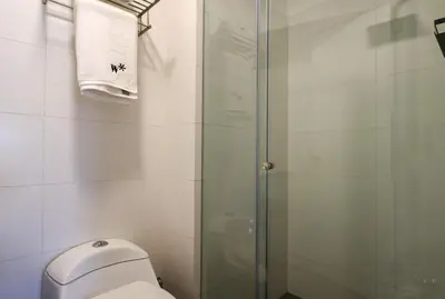 a bathroom with a toilet and a glass shower at Stelar by Wynwood House in Lima