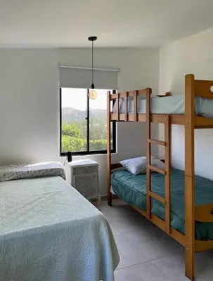 a bedroom with two bunk beds and a window at Casa Tullpa in Aspitia