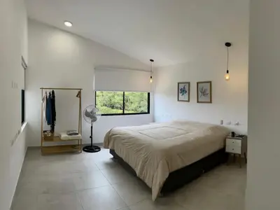 a white bedroom with a large bed and a window at Casa Tullpa in Aspitia