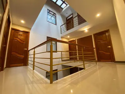 a spiral staircase in a house with wooden doors at INKALAM cusco in Cusco