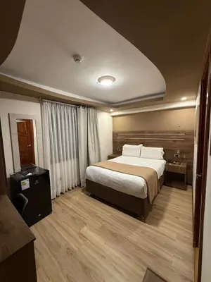a bedroom with a large bed in a room at INKALAM cusco in Cusco