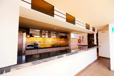 a kitchen with a long counter in a room at INKALAM cusco in Cusco