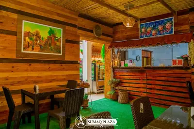 a dining room with wooden walls and a table and chairs at Hotel SumacPlaza in Ayacucho