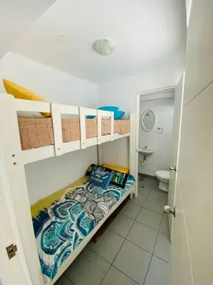 a small bathroom with a bunk bed and a toilet at Alojamiento frente al mar en San Bartolo in San Bartolo
