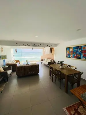 a living room with a table and a couch at Alojamiento frente al mar en San Bartolo in San Bartolo