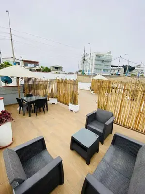 a patio with black furniture and a table and chairs at Alojamiento frente al mar en San Bartolo in San Bartolo