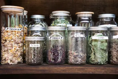 a row of jars filled with different types of herbs at Casa Tikawarmi in Urubamba