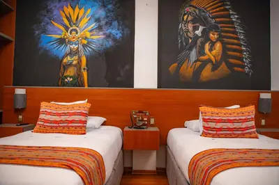 a room with two beds and a painting on the wall at Chakana Hotel Machupicchu in Machu Picchu