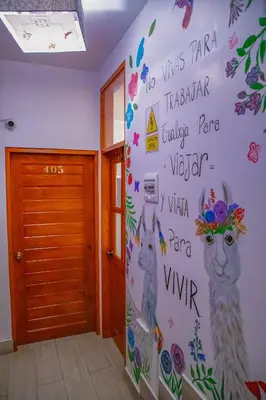 a wall in a room with a mural of llamas at Chakana Hotel Machupicchu in Machu Picchu