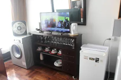 a tv sitting on top of a entertainment center at Palmeras Apartments San Isidro in Lima